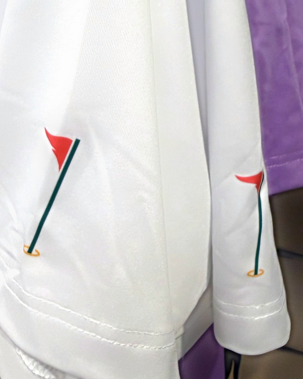 Pin flag detail on the polo sleeve